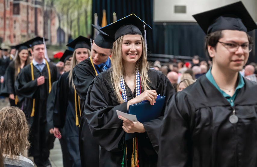 Graduate smiling at graduation.