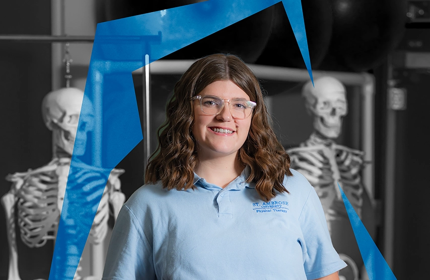 Sara Haller stands among educational skeletons, she smiles into the camera as the Ambrosian Arc surrounds her.