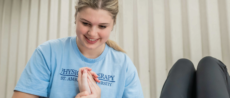 Physical therapy student working with patient during clinical.