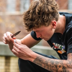 Student collecting a soil sample for a BS in Biology lab assignment.