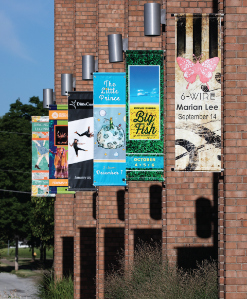 Exterior of Galvin Fine Arts Center featuring colorful banners of upcoming performances.