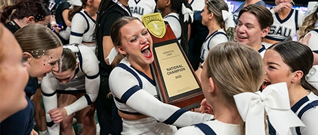 SAU Cheer shout with joy after wining the 2023 NAIA Cheer Championships.