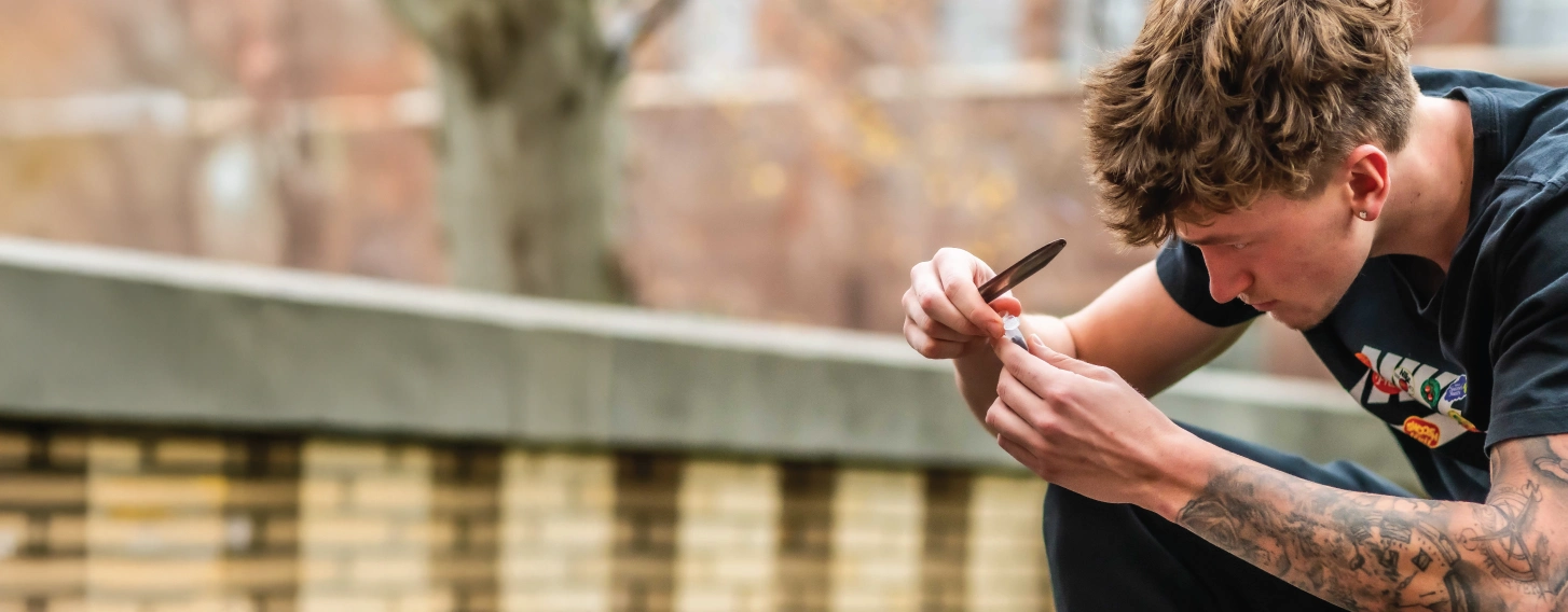 Student collecting a soil sample for a BS in Biology lab assignment.
