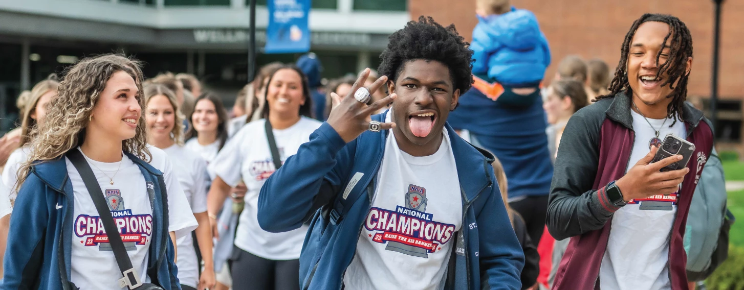 Students flaunt their championship ring while walking to the Cheer and Dance event.