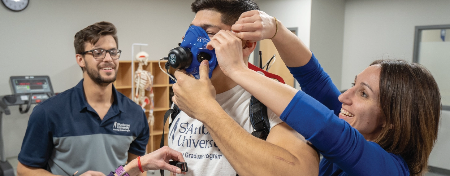 Group of kinesiology students and teacher practicing assessment in a lab.
