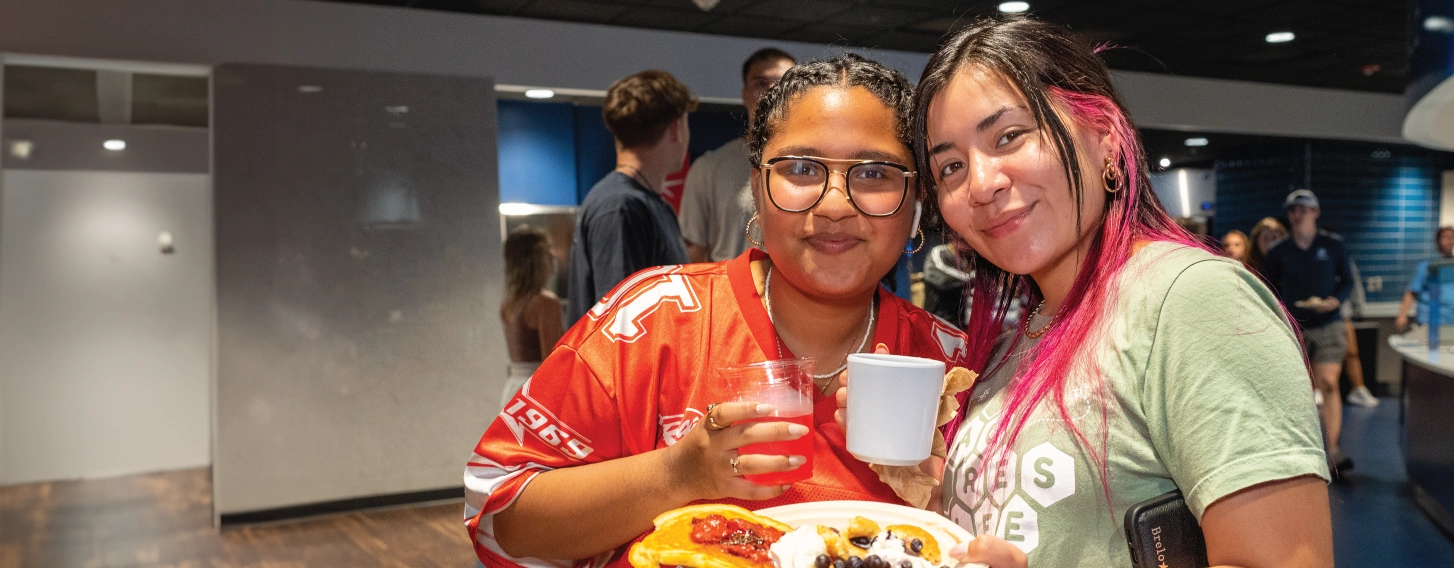 Two students during an event in the dining hall.