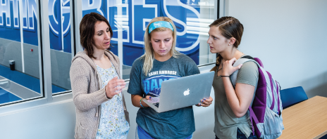 Sport management students in classroom overlooking athletic facilities.