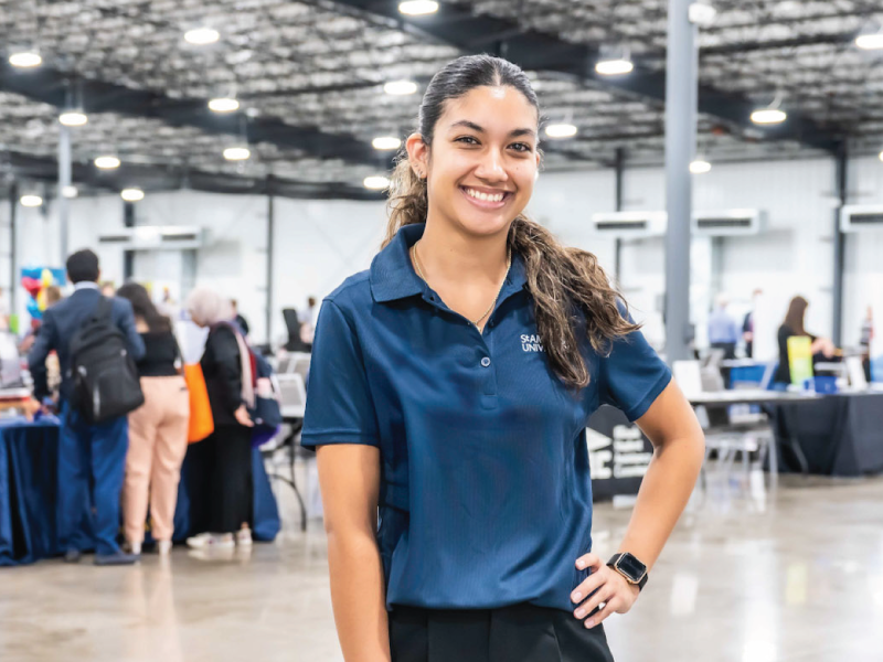 A student smiling during a career fair.