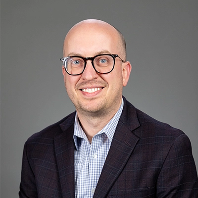 Jason Fluchel smiles into the camera.