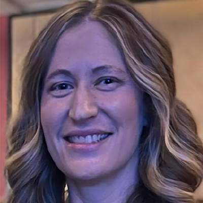 Meghan Ward smiles into the camera.