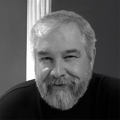 Steve Berger smiles into the camera in a black and white photo.